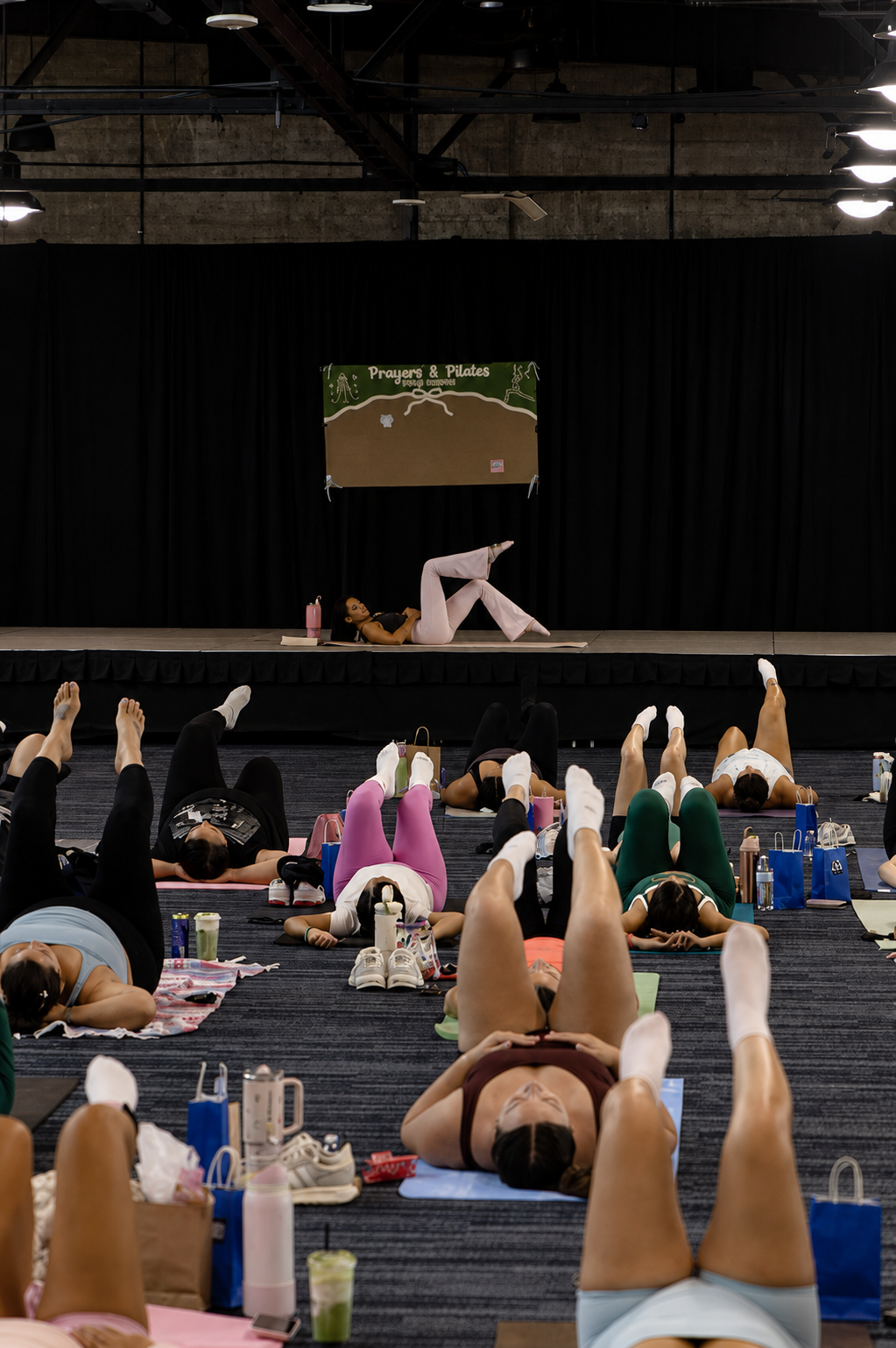 Group Pilates class with participants on mats in a bright studio